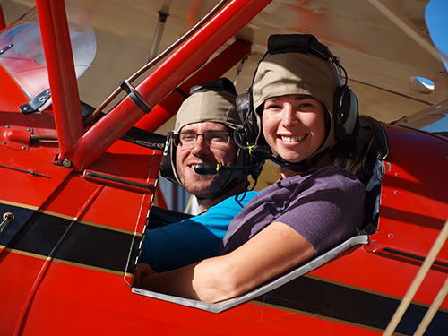 Tim and Amelie geared up and in the biplane