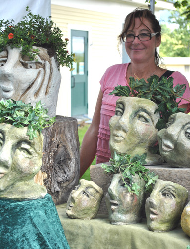 Valerie McCaffrey poses with a number of her garden guardians
