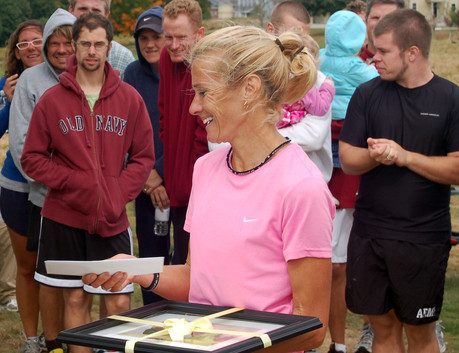 Christine Reaser, first place woman in the 2010 Laudholm 5K, accepts her prize