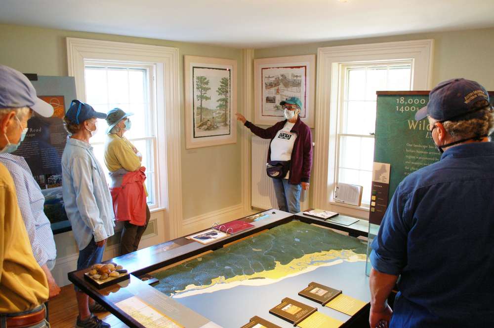 Linda Littlefield Grenfell uses  artwork by James E. Francis, Sr. to focus discussion during a Wabanaki Wonderings walk this fall. The art is new to the Changing Landscapes exhibit in the Visitor Center. Photo: Scott Richardson.