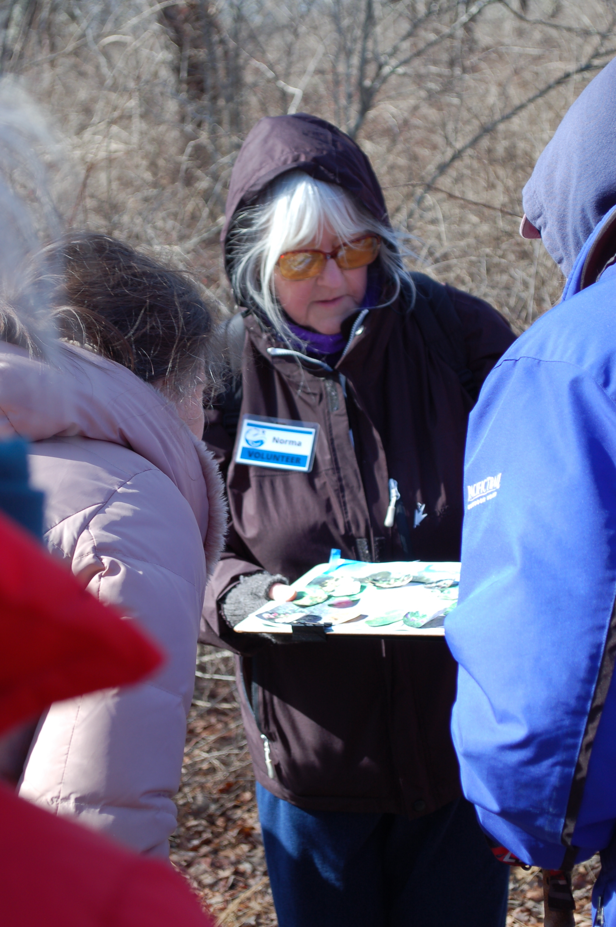 A docent makes a presentation during a winter walk at the Wells Reserve.