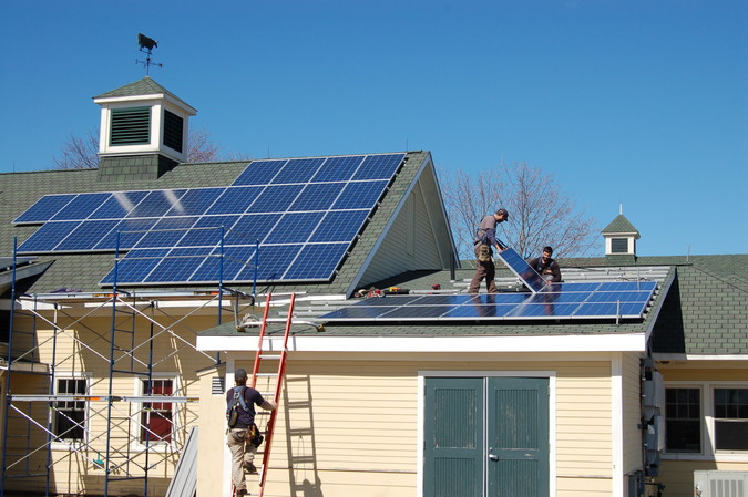 Solar panel installation in progress on Maine Coastal Ecology Center in March 2013