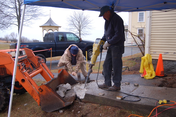 Frank and John, with jackhammer and sledge, team up to break up the obsolete concrete ramp.