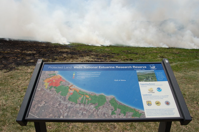 Protected Lands sign with prescribed burn in background