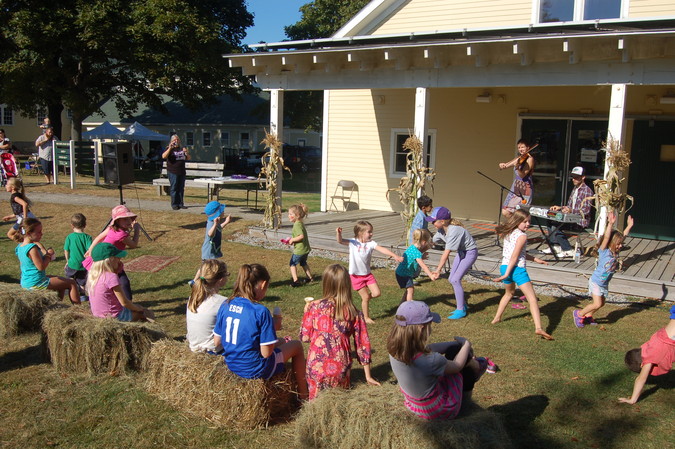 Children dance and play in front of the music porch at the 12th Punkinfiddle