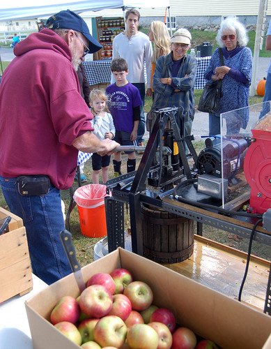 Dan Smith pressed apples for cider as kids and adults look on and wait for samples. 2016 Punkinfiddle.