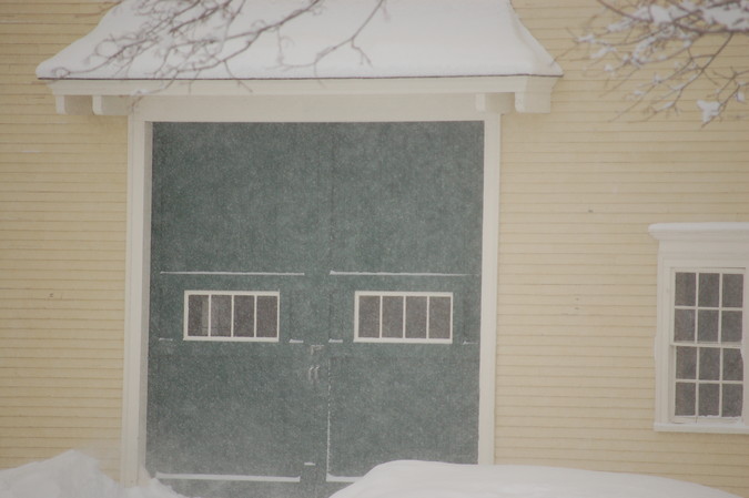 Snow blowing past the big barn's double doors, February 5, 2015