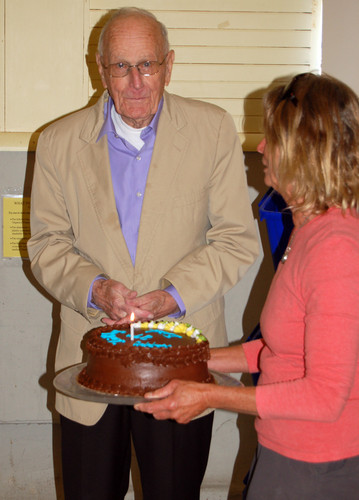 Dick Eaton accepts a birthday cake from Nancy Viehmann