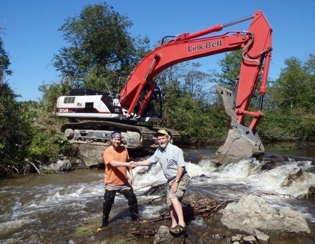 Jake Aman of the Wells Reserve and Steve Heinz of the Sebago Chapter of Trout Unlimited celebrate the removal of a dam from Goff Mill Brook in Arundel.