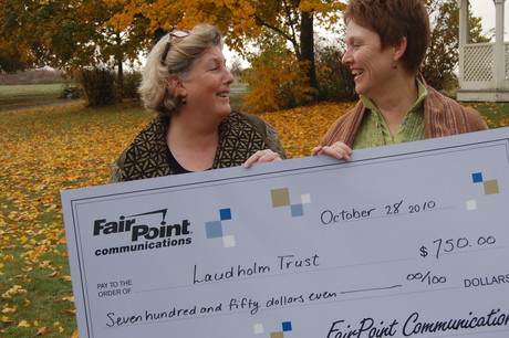 FairPoint's Leslie Roberts shares a donation with Laudholm president Diana Joyner