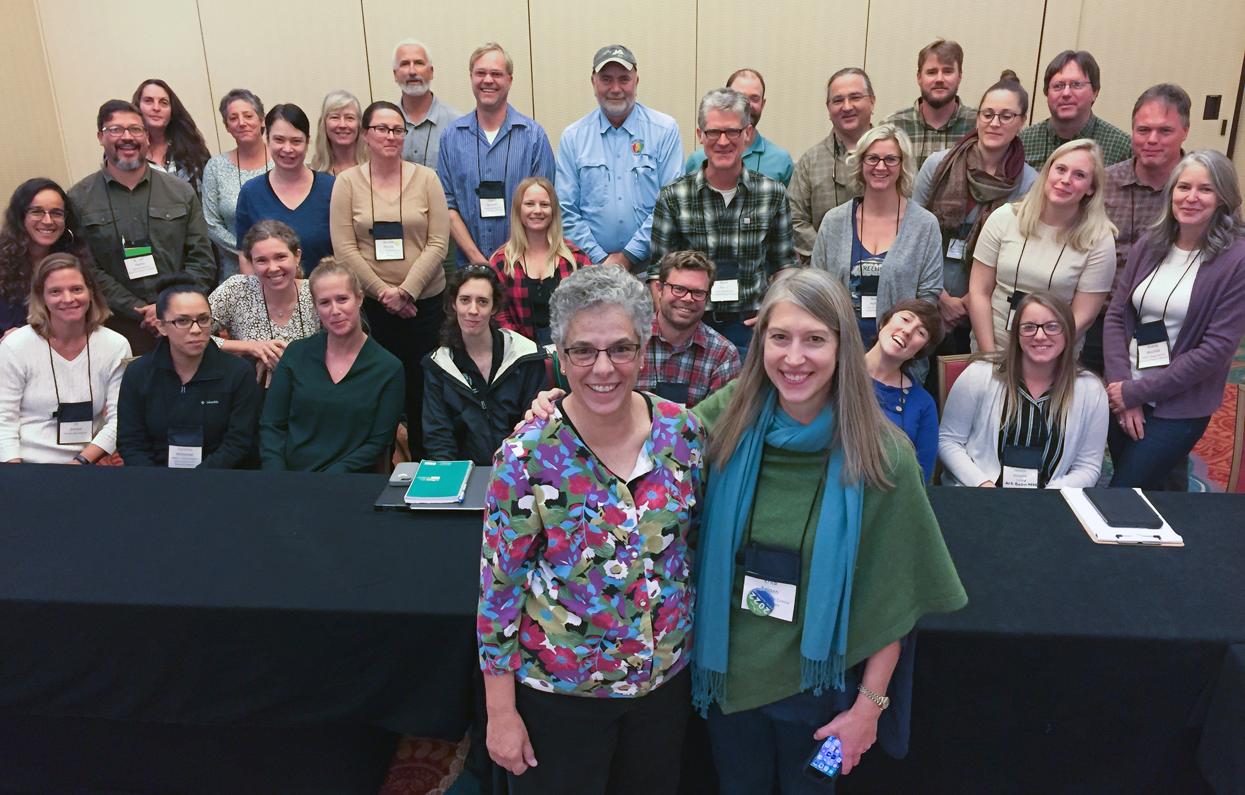 Sue Bickford (front left) accepts congratulations from NOAA Program Manager Erica Seiden at the 2019 NERRS/NERRA meeting. They are joined by stewardship coordinators and others from throughout the system.