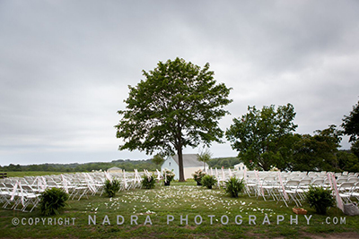 Wedding chairs overlook fields. Photo © Nadra Photography.